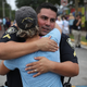 University Of Central Florida Police officer Pablo Vargas receives a hug from Christine Gigico